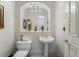 Powder room with pedestal sink, decorative mirror, and elegant lighting at 277 Dark Forest Ave, Las Vegas, NV 89123