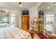 Elegant bedroom with full mirrored wall, decorative vanity, and TV at 277 Dark Forest Ave, Las Vegas, NV 89123