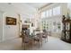 Elegant dining room boasts a glass table, chandelier, fireplace, and sun-filled windows with beautiful shutters at 277 Dark Forest Ave, Las Vegas, NV 89123
