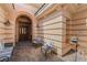 Elegant entrance featuring an arched doorway, outdoor seating, and decorative lighting, creating a welcoming ambiance at 277 Dark Forest Ave, Las Vegas, NV 89123