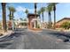Gated entrance with prominent lion statues and lush, mature palm trees at 277 Dark Forest Ave, Las Vegas, NV 89123