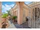 Inviting entrance with an iron gate, decorative plants, and a charming seating area, adding character at 277 Dark Forest Ave, Las Vegas, NV 89123