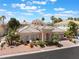 Beautiful exterior home elevation with a decorative tile roof, a circular turret, and manicured landscaping at 277 Dark Forest Ave, Las Vegas, NV 89123