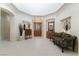 Grand foyer with decorative lighting, tile floors, and wooden doors, leading to a spacious interior at 277 Dark Forest Ave, Las Vegas, NV 89123