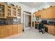 Spacious kitchen featuring custom cabinets, granite countertops, and desk area with wine fridge at 277 Dark Forest Ave, Las Vegas, NV 89123