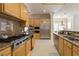Gourmet kitchen features stainless steel appliances, granite counters, and custom wood cabinetry at 277 Dark Forest Ave, Las Vegas, NV 89123