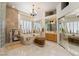 The main bathroom features a soaking tub, vanity, chandelier, and decorative accents at 277 Dark Forest Ave, Las Vegas, NV 89123