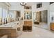 An elegant main bathroom features marble floors, soaking tub, large mirrors and and vanities at 277 Dark Forest Ave, Las Vegas, NV 89123