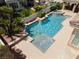 Backyard view of an inground pool with multiple tiers and lush landscaping at 277 Dark Forest Ave, Las Vegas, NV 89123