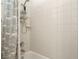 Standard shower tub combination features a white tiled shower and shower caddy at 277 Dark Forest Ave, Las Vegas, NV 89123