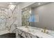 Elegant bathroom showcasing marble finishes, double sinks with gold fixtures, and a glass-enclosed shower at 3111 Bel Air Dr # 27E, Las Vegas, NV 89109