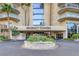 A beautifully landscaped entrance to Regency Towers, featuring lush greenery and a circular driveway at 3111 Bel Air Dr # 27E, Las Vegas, NV 89109