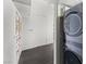 Laundry room features a stacked washer and dryer next to the decorated hallway doors at 3111 Bel Air Dr # 27E, Las Vegas, NV 89109