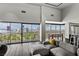 Bright living room featuring hardwood floors, floor to ceiling windows and stunning views of the Las Vegas skyline at 3111 Bel Air Dr # 27E, Las Vegas, NV 89109