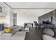 Bright open-concept living room with dark hardwood floors, wet bar, marble accent wall, and modern decor at 3111 Bel Air Dr # 27E, Las Vegas, NV 89109