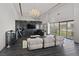 Open-concept living room features a marble accent wall, unique decor, and floor to ceiling windows with city views at 3111 Bel Air Dr # 27E, Las Vegas, NV 89109