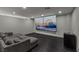Modern living room with a sectional sofa and a large video screen on the wall at 3111 Bel Air Dr # 27E, Las Vegas, NV 89109
