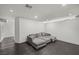 Modern living room with a sectional sofa and dark hardwood-style flooring at 3111 Bel Air Dr # 27E, Las Vegas, NV 89109