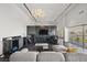 Bright living room featuring a bar area, marble accent wall with TV, chandelier and floor to ceiling windows at 3111 Bel Air Dr # 27E, Las Vegas, NV 89109