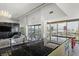 Spacious open-concept living area featuring wood floors, recessed lighting, and an island with barstool seating at 3111 Bel Air Dr # 27E, Las Vegas, NV 89109