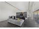 Open-concept living room features a marble accent wall, unique decor, and floor to ceiling windows with city views at 3111 Bel Air Dr # 27E, Las Vegas, NV 89109
