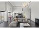 Open-concept living room featuring a plush sofa, dark wood floors, a chandelier, and city views at 3111 Bel Air Dr # 27E, Las Vegas, NV 89109