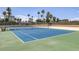 Outdoor tennis court on a sunny day featuring a green and blue surface, surrounding fence, and net at 3111 Bel Air Dr # 27E, Las Vegas, NV 89109
