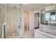 Bathroom boasts a glass shower, toilet room, large mirror, and soaking tub, creating a spa-like retreat at 322 Karen Ave # 601, Las Vegas, NV 89109