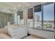 Bathroom with white cabinetry, tiled floor, and a large window providing great natural light and city views at 322 Karen Ave # 601, Las Vegas, NV 89109