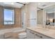 Bathroom with a tub, a toilet, a vanity with sink, and a window offering views of the city and mountains at 322 Karen Ave # 601, Las Vegas, NV 89109