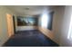 Bright bedroom with large window and ample natural light, featuring blue carpet at 3232 Dayflower St # 4, Las Vegas, NV 89121