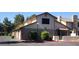 Two-story townhouse featuring a tan exterior with brick accents and a well-maintained landscape at 3232 Dayflower St # 4, Las Vegas, NV 89121