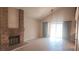 Spacious living room features a brick fireplace, vaulted ceilings, and new floors at 3232 Dayflower St # 4, Las Vegas, NV 89121
