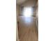 Open-concept living room with new laminate floors and a sliding glass door at 3232 Dayflower St # 4, Las Vegas, NV 89121