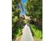Charming walkway lined with lush greenery leading to cozy townhomes in a quiet community at 3232 Dayflower St # 4, Las Vegas, NV 89121