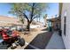 Spacious backyard featuring a covered patio, mature trees, and ample space for recreation at 3236 Manzanita Ln, Laughlin, NV 89029