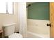 Clean bathroom with a combined shower-tub, white fixtures, and a window at 3236 Manzanita Ln, Laughlin, NV 89029