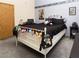 Bedroom with a white iron bed frame, black bedding, and whimsical decor at 3236 Manzanita Ln, Laughlin, NV 89029