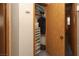 Walk-in closet featuring wood door, shelving and storage containers for optimal organization at 3236 Manzanita Ln, Laughlin, NV 89029