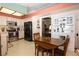 Traditional kitchen with stainless steel appliances, white cabinets, and a light-filled dining area at 3236 Manzanita Ln, Laughlin, NV 89029