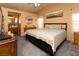 Bright main bedroom featuring plush carpeting, neutral paint and an ensuite bathroom at 3236 Manzanita Ln, Laughlin, NV 89029