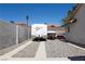Oversized RV parking with gravel and concrete driveway, accommodating boat and trailer, surrounded by stucco home and block wall at 3236 Manzanita Ln, Laughlin, NV 89029