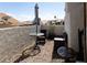 Outdoor patio featuring gravel, stucco wall, table and chairs, offering a relaxing space at 3236 Manzanita Ln, Laughlin, NV 89029