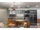 Close-up of the kitchen with modern appliances, wooden cabinets, and a glass-topped dining table with seating for four at 3726 Las Vegas Blvd # 606, Las Vegas, NV 89158