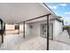 Covered back patio with tiled floor provides access to the backyard and convenient storage shed at 4237 E Twain Ave, Las Vegas, NV 89121