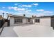 Backyard with a concrete patio, black gates, and a white exterior wall with solar panels at 4237 E Twain Ave, Las Vegas, NV 89121