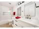 Updated bathroom featuring double sinks, modern fixtures, and a marble shower with a tub at 4237 E Twain Ave, Las Vegas, NV 89121