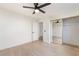 Bedroom featuring laminate flooring, ceiling fan, and mirrored closet doors at 4237 E Twain Ave, Las Vegas, NV 89121