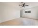 Minimalist bedroom with light hardwood floors, a ceiling fan and a window at 4237 E Twain Ave, Las Vegas, NV 89121