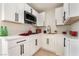 Well-lit kitchen with white cabinets, stainless steel microwave, and modern finishes at 4237 E Twain Ave, Las Vegas, NV 89121